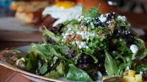 Rokka Salad with goat cheese, mango, grapes, and candied walnuts