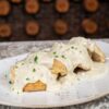 Biscuits and Gravy (Side of two biscuits topped with sausage gravy and chopped parsley)